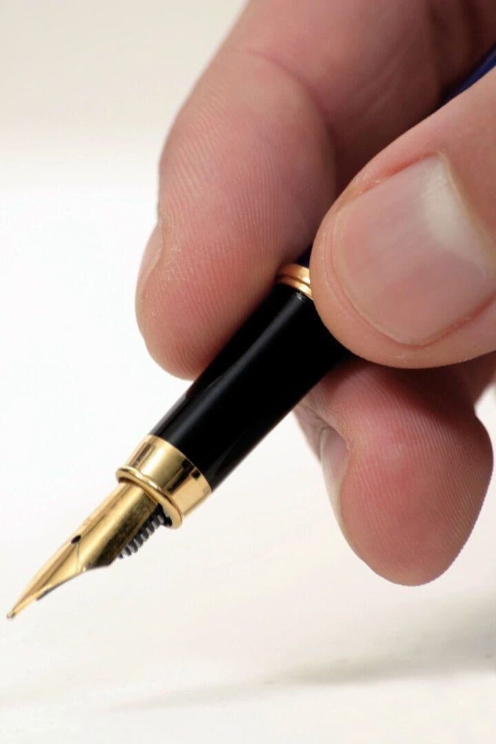 A person holding a pen in their hand